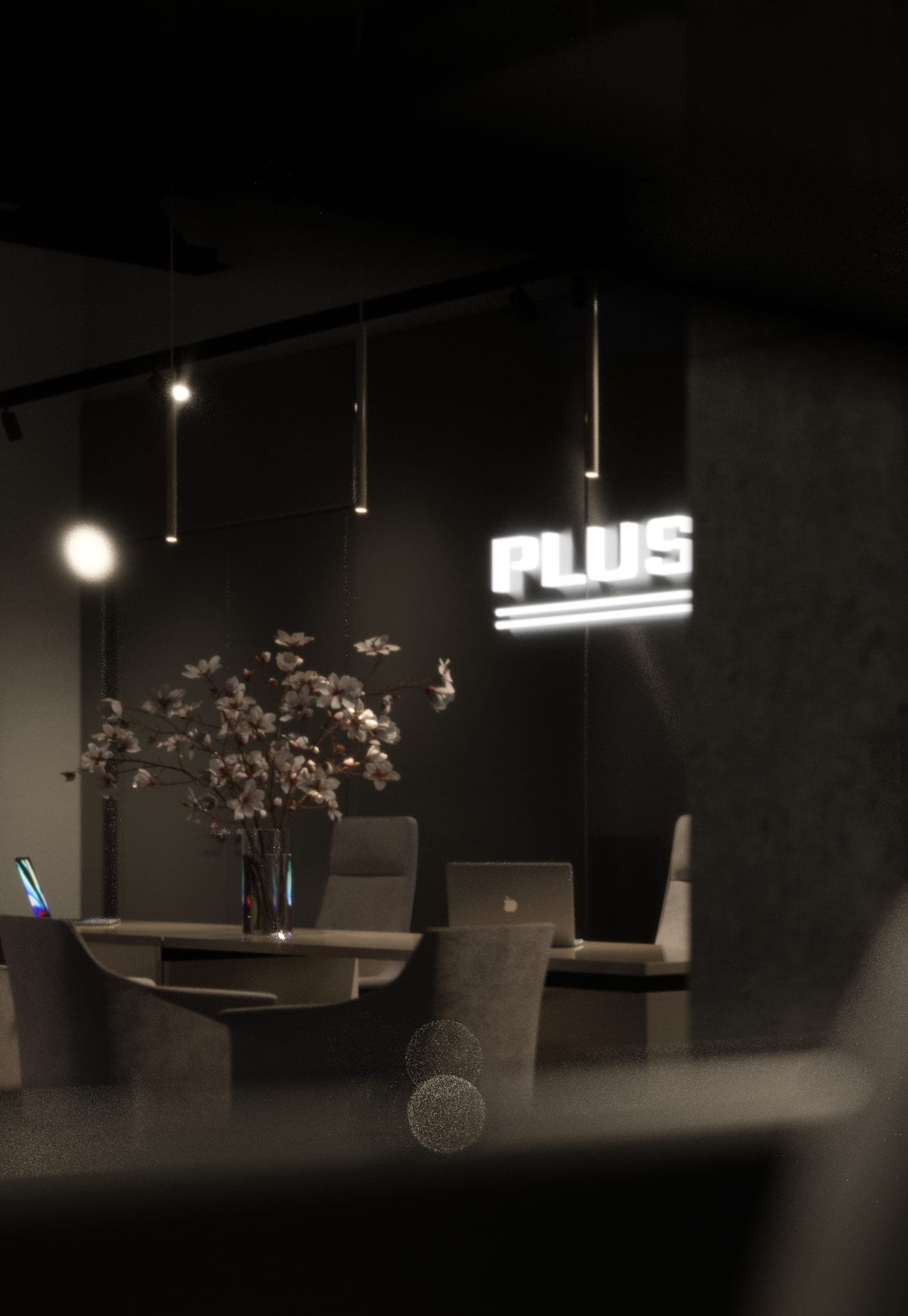 Plus Auto: consultation table with flowers beneath the illuminated sign, in low light