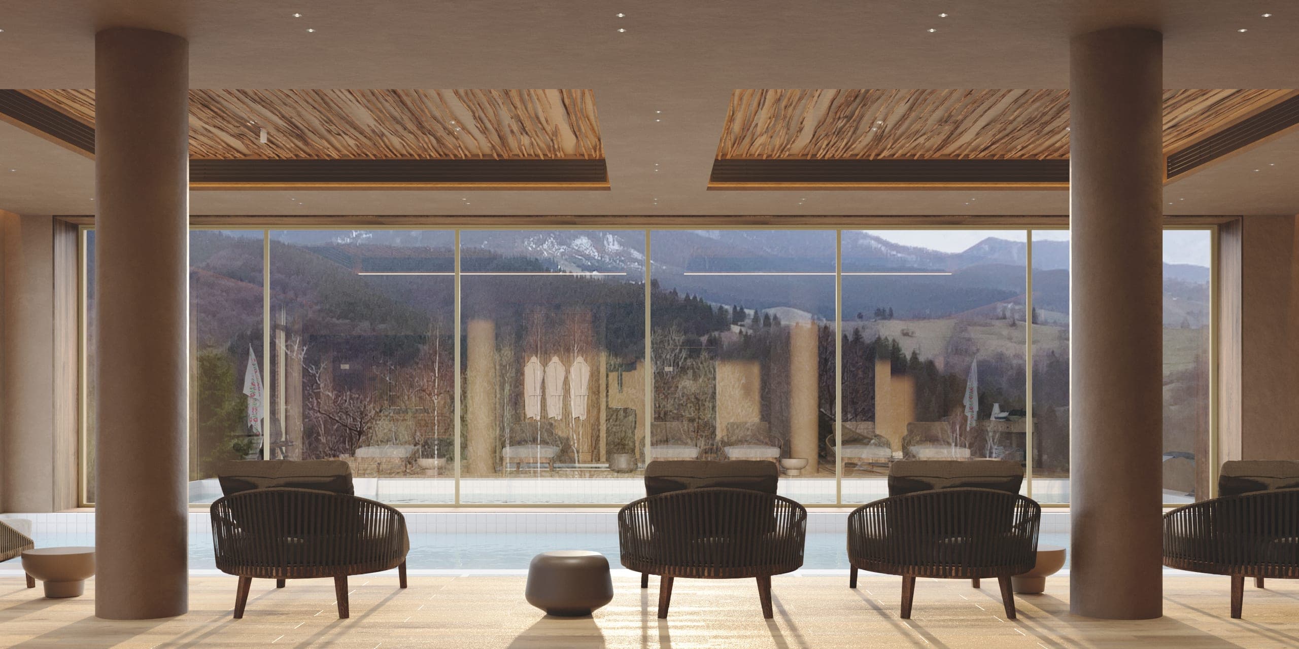 Natura Spa: indoor pool lounge with armchairs facing the mountains