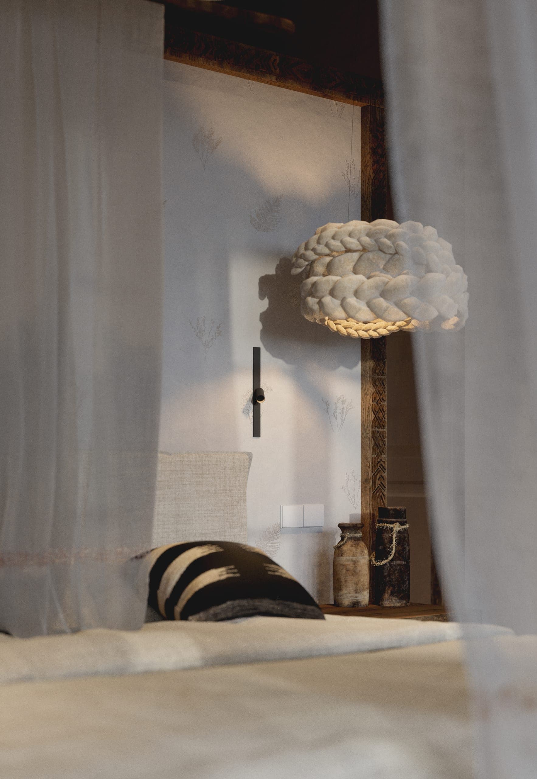 Matca private villa: plaster wall with a sculptural wall light and draped linen