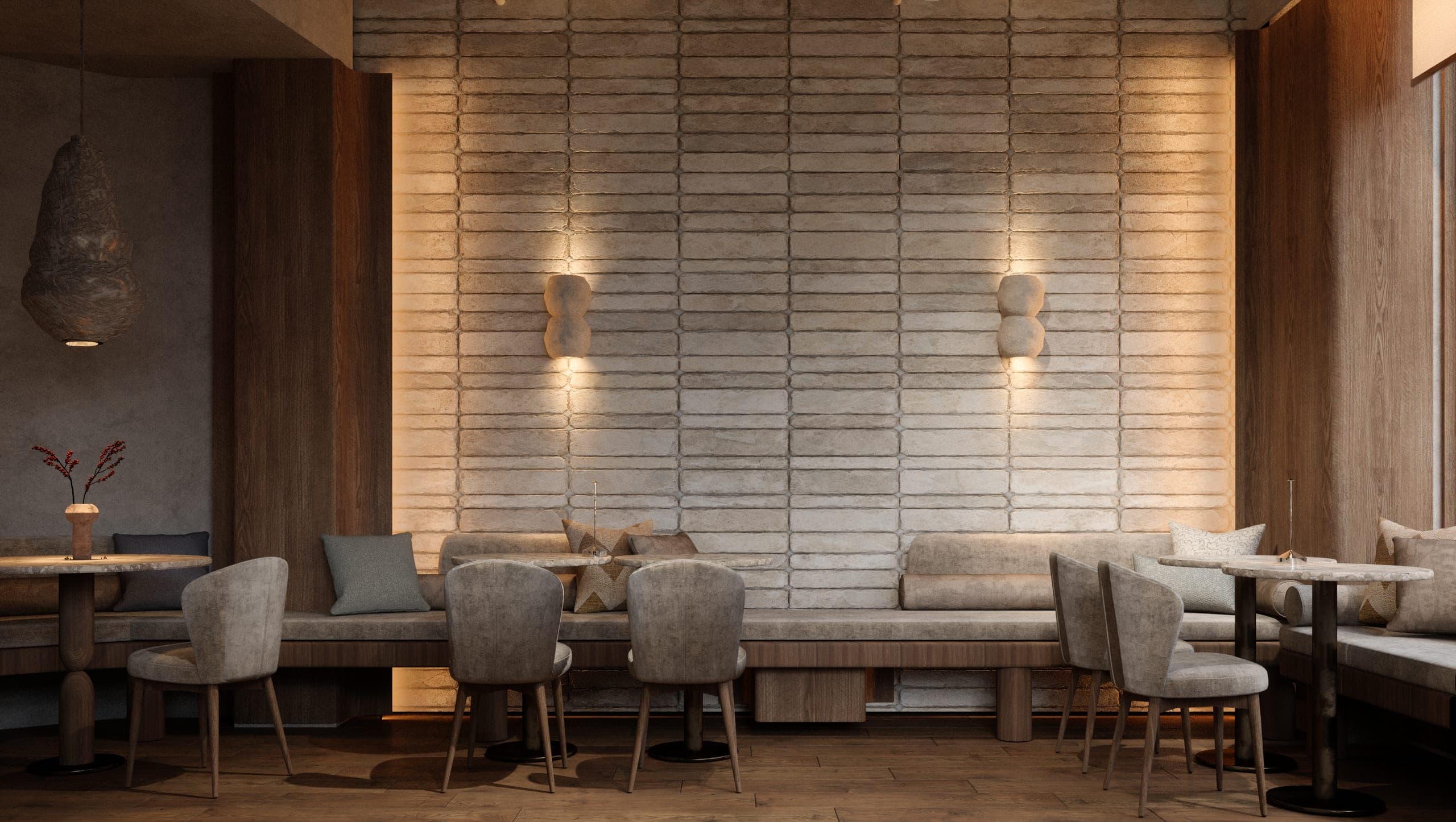 Gran Adamo: banquette along a wall of irregular ceramic tiles with sculptural wall lights