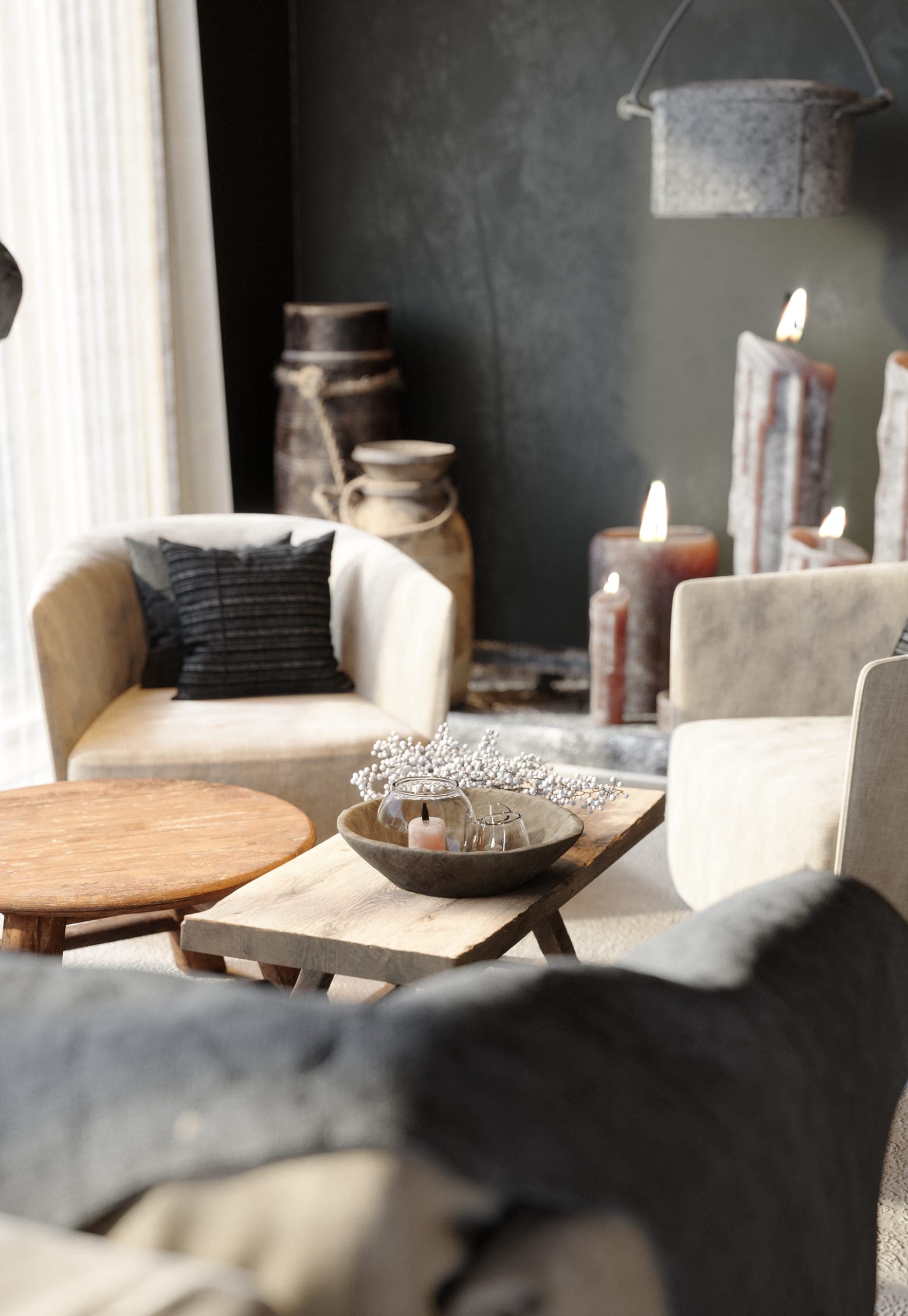 Matca lounge: armchair and low table beside candles at the fireplace