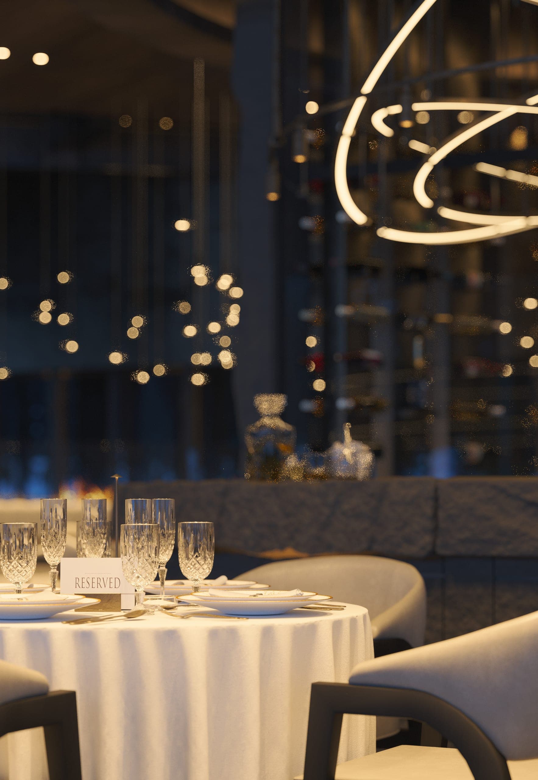 Hotel Peștera restaurant: round table laid with crystal, the wine display behind