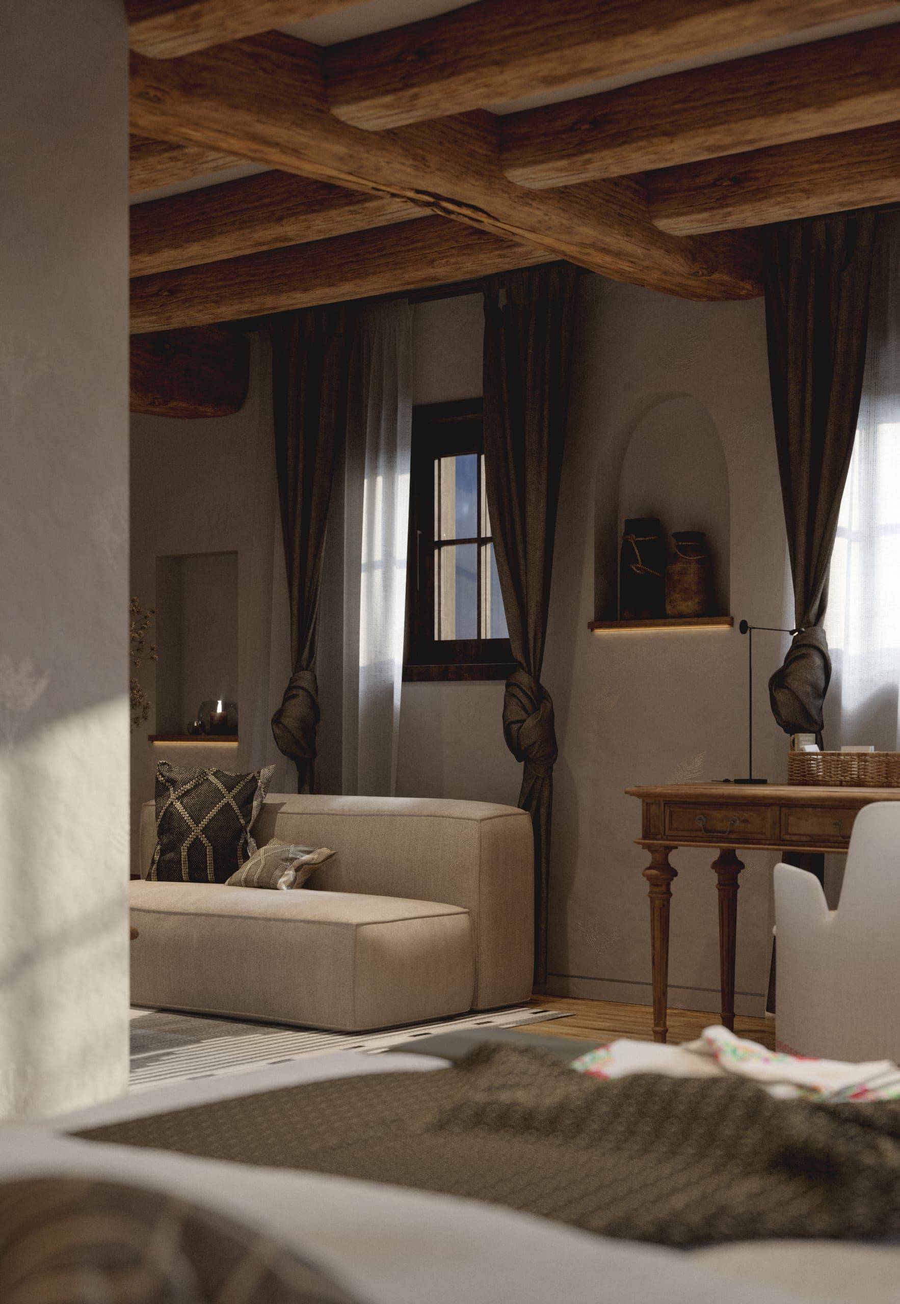 Matca guest room: sitting corner with a cream armchair, timber desk and exposed beams