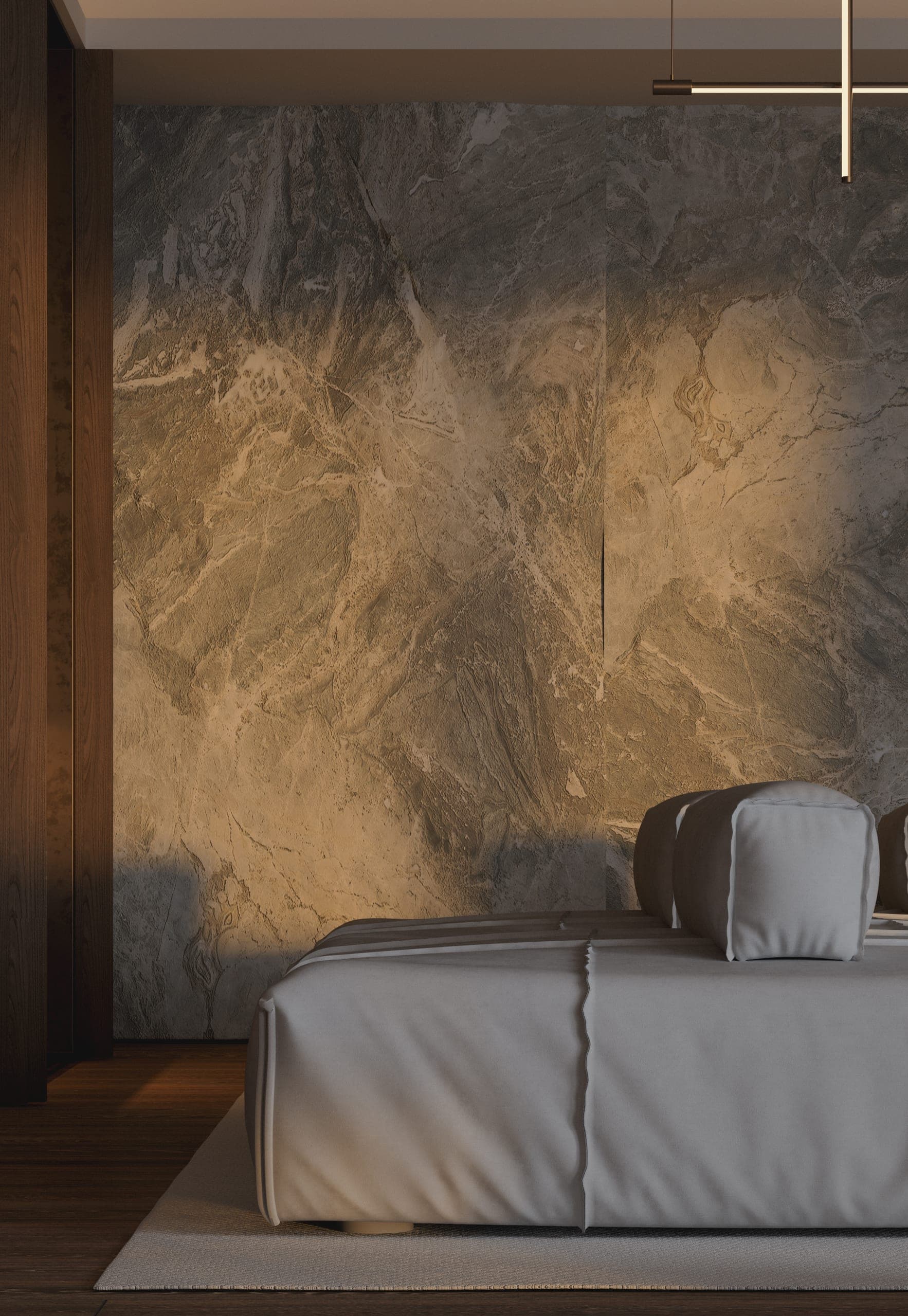 Opera Residence Apartment: low sofa against a stone-textured wall washed with warm light
