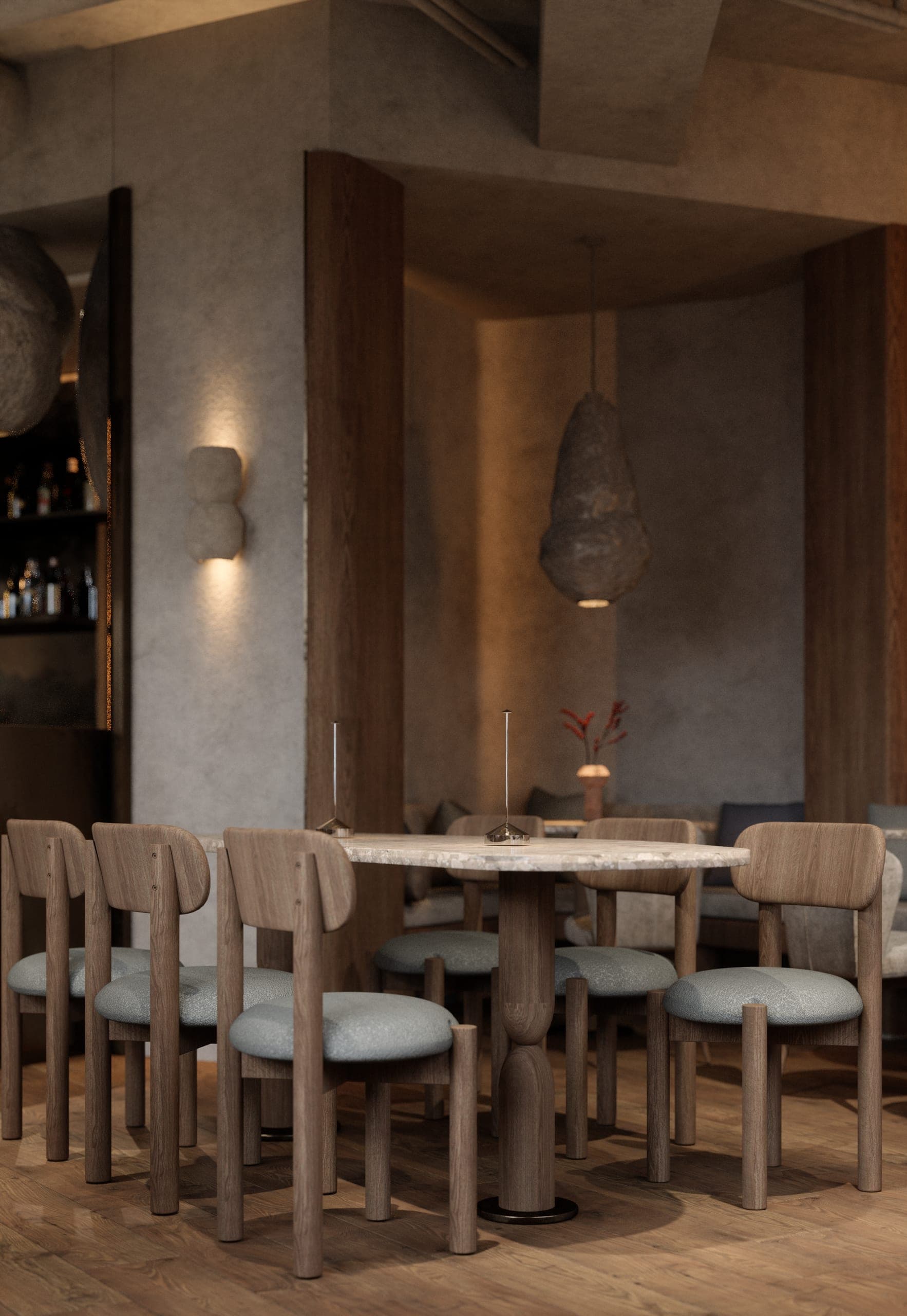 Gran Adamo: round table and upholstered chairs beneath a woven pendant