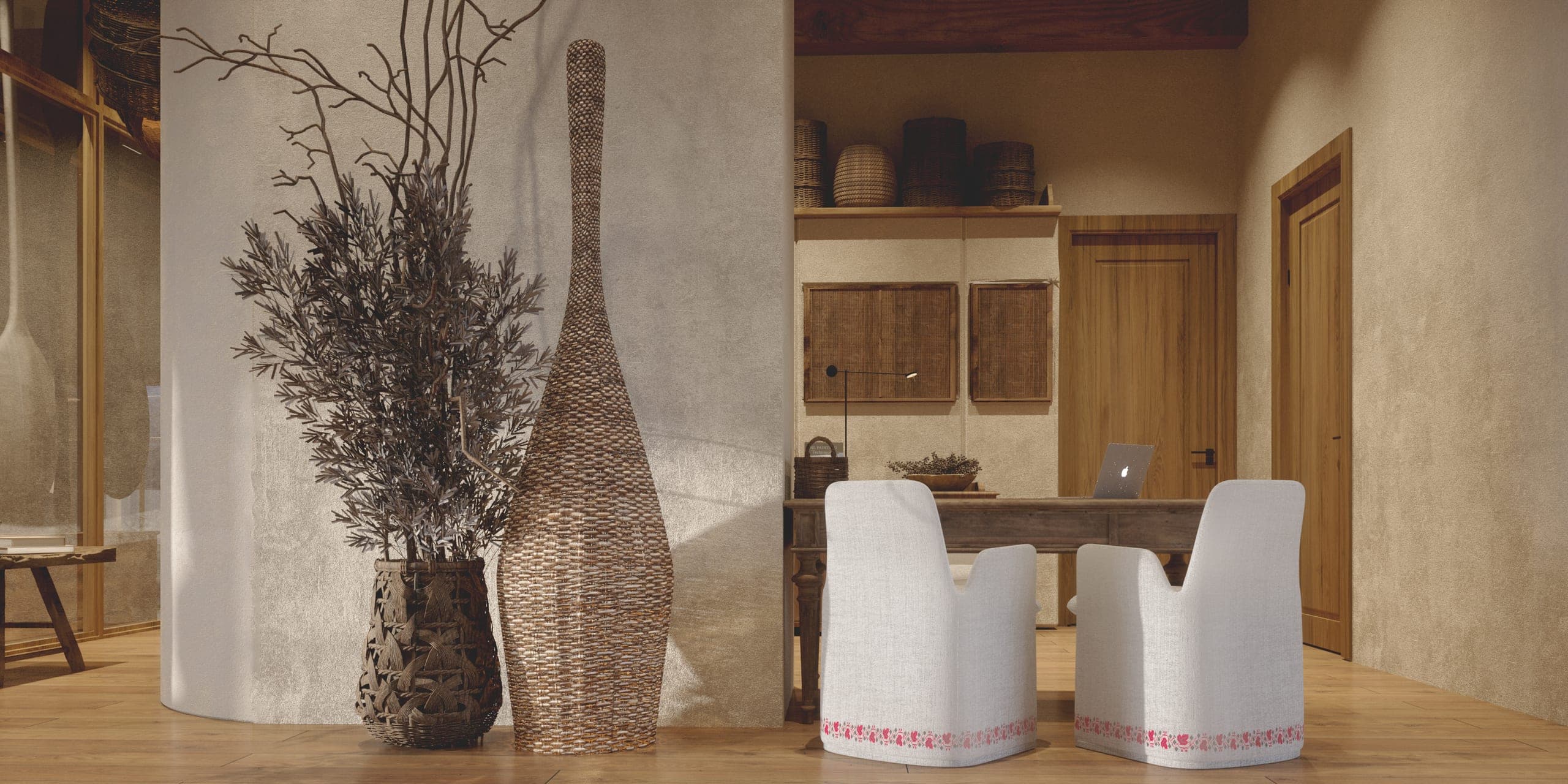 Matca reception: desk with two upholstered chairs beside tall woven vessels