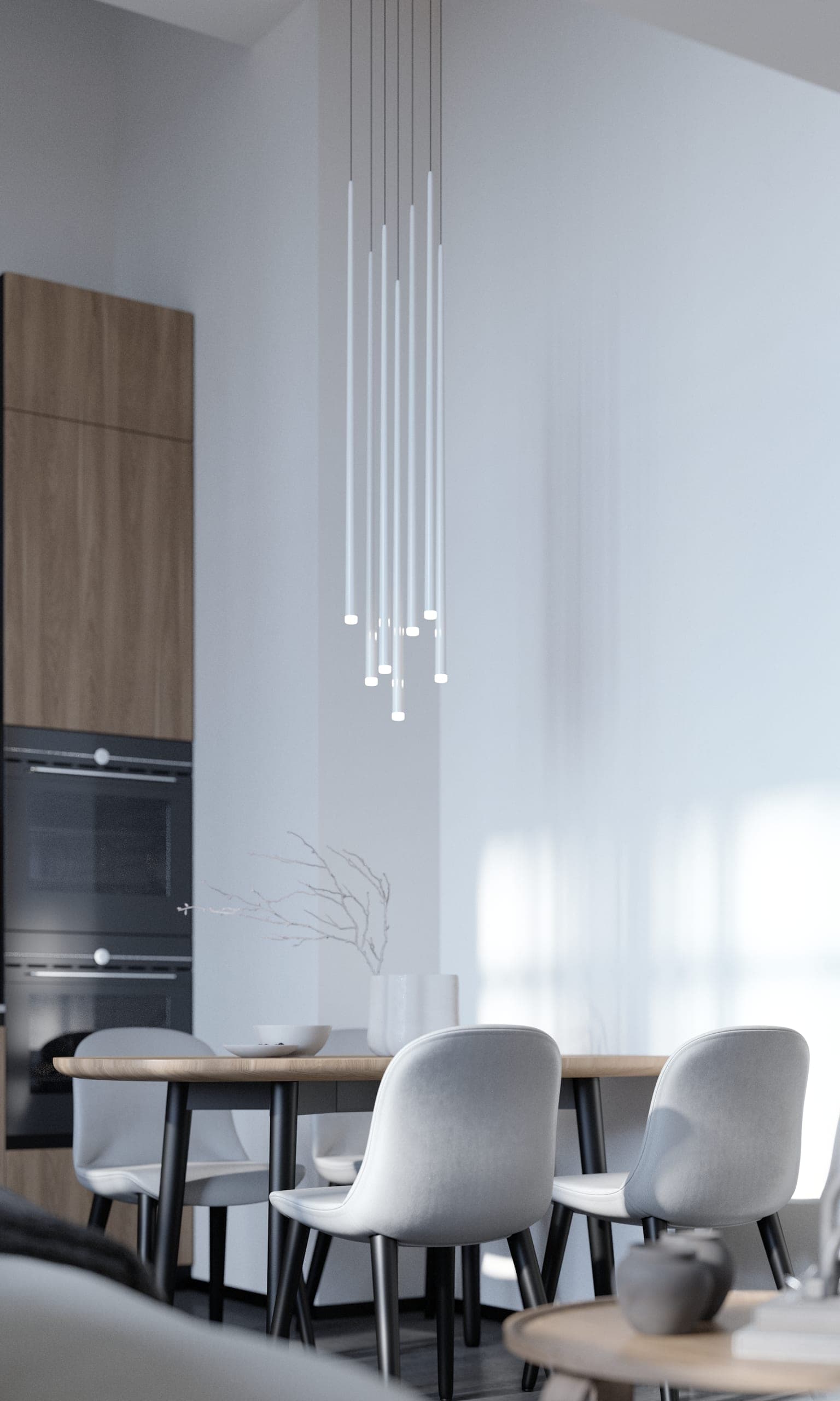 Plauen Apartment: dining table with white chairs beneath a cluster of slim pendant lights