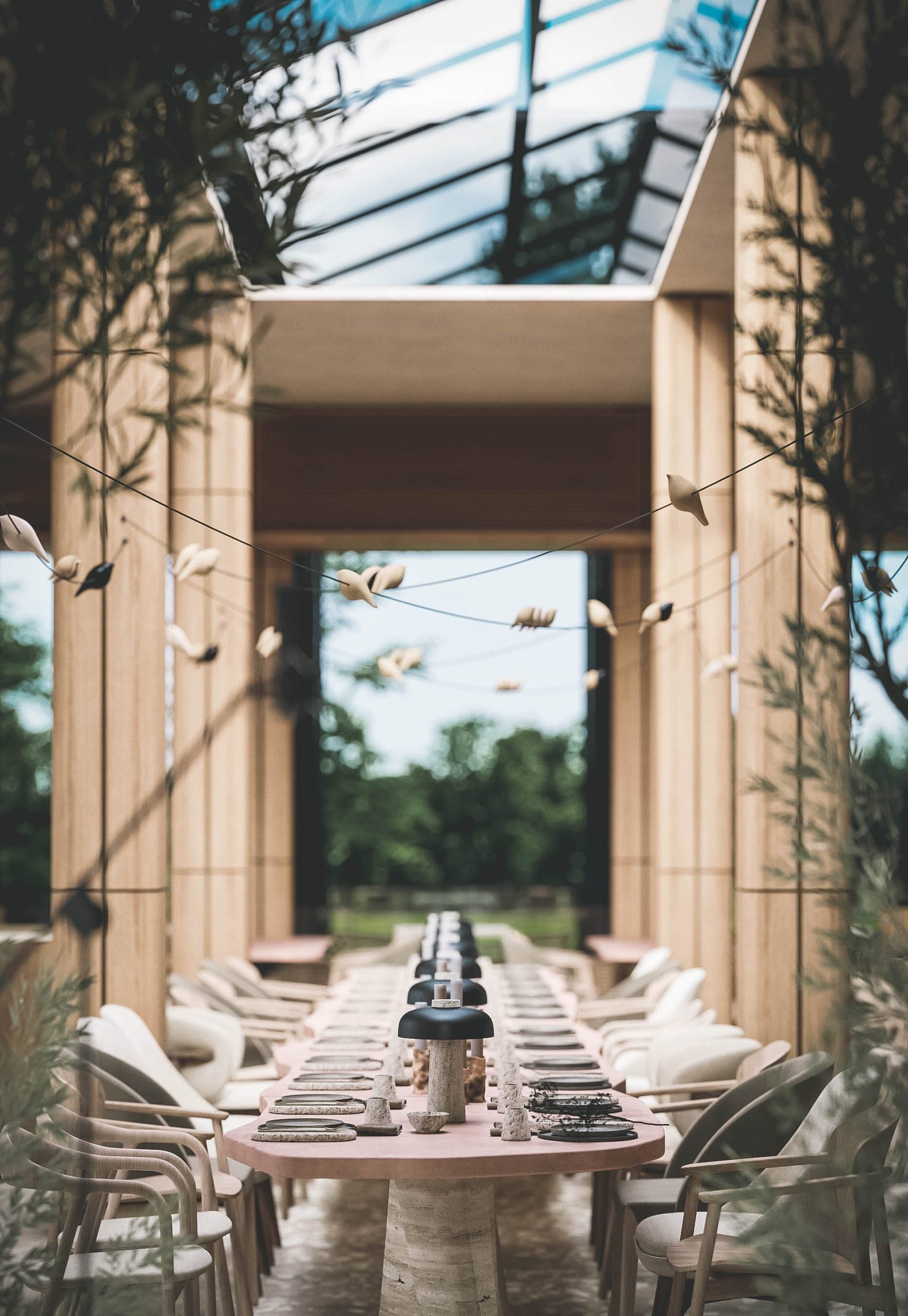 Bosco: long dining table in a double-height timber volume under a glass roof