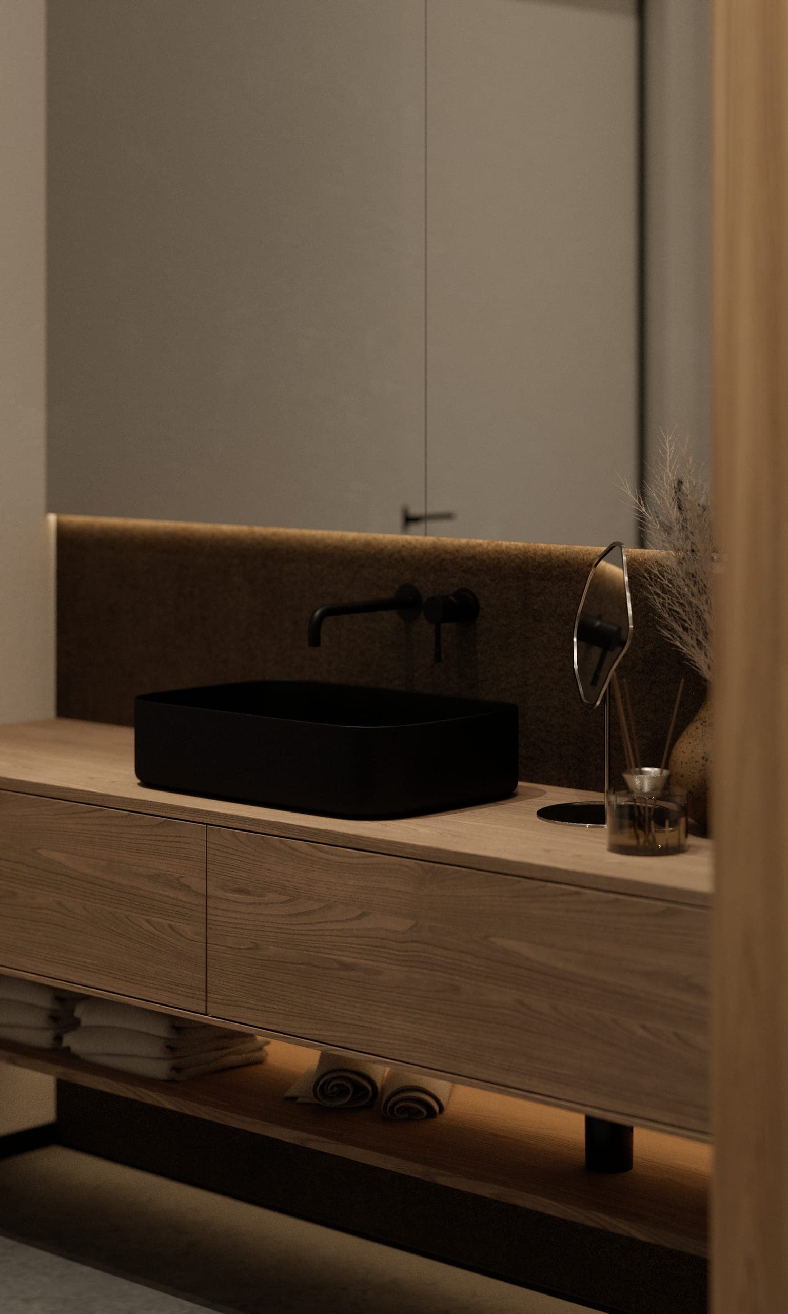 Plauen Apartment: timber vanity with a black basin and wall-mounted tap, lit from below