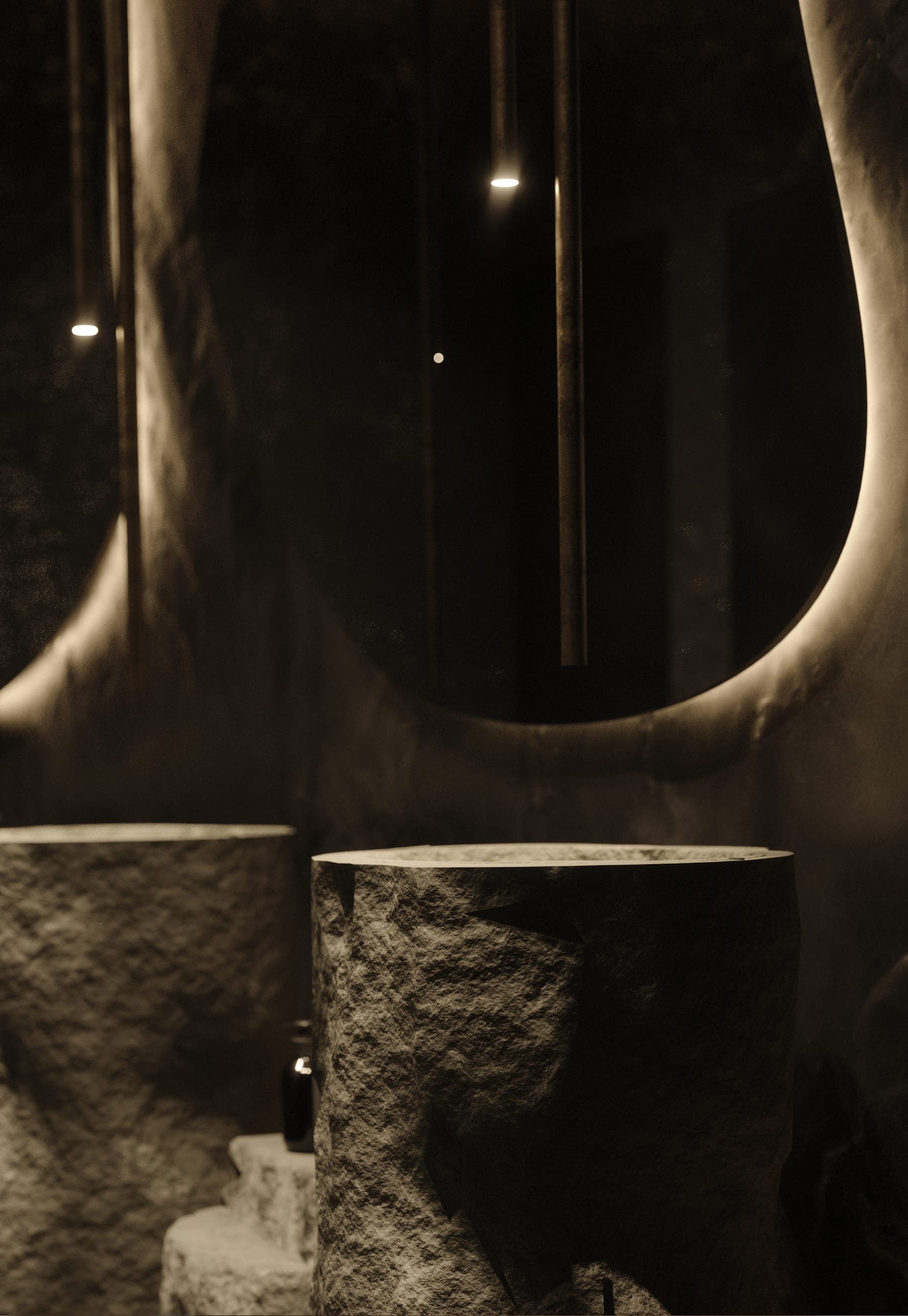 Hotel Peștera restaurant: rough stone basins in a washroom with sculpted dark walls