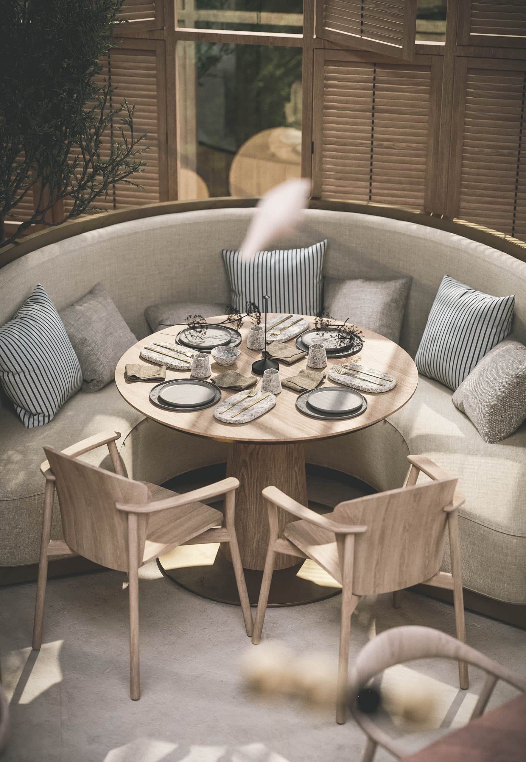Bosco: round table in a curved upholstered booth, seen from above