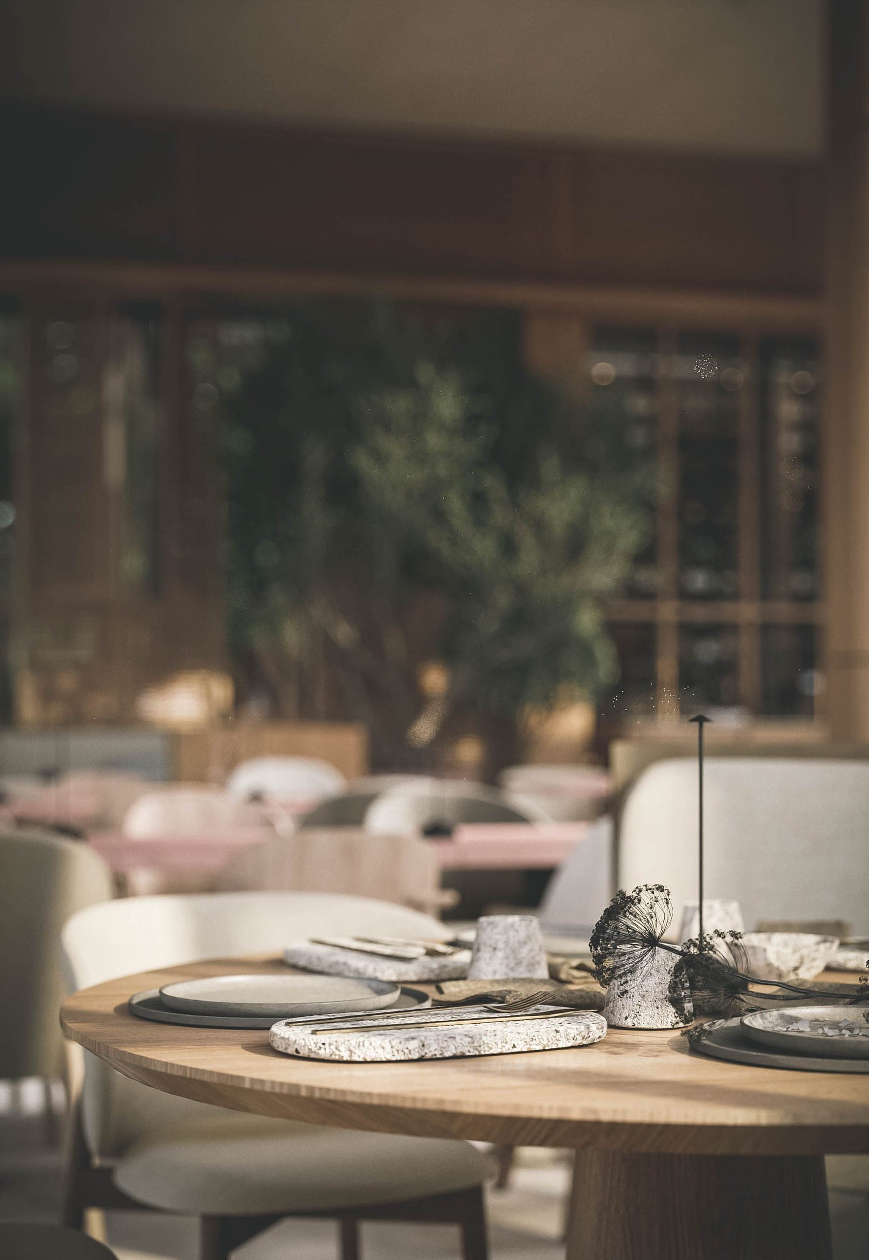 Bosco: laid round table in soft focus
