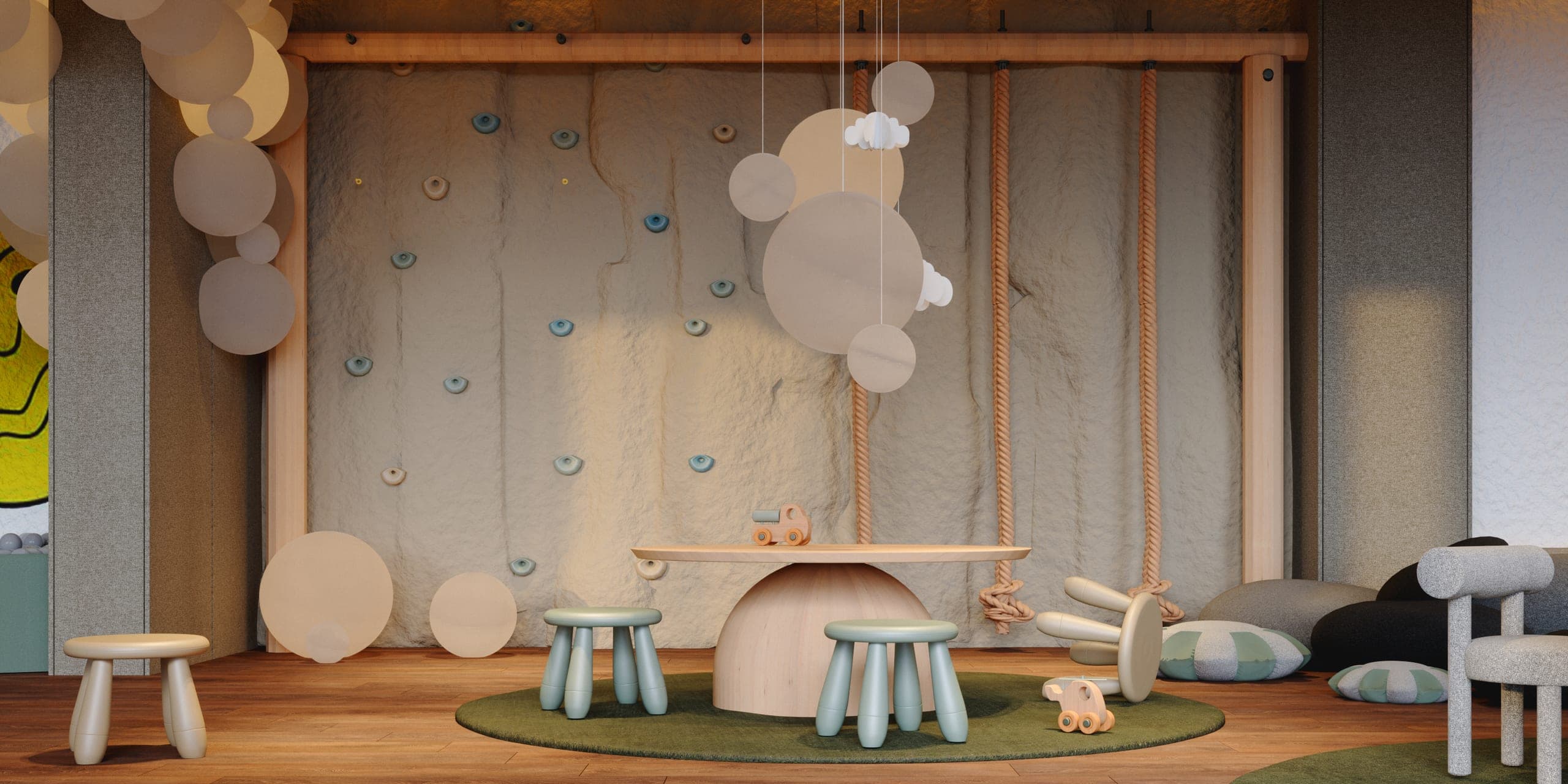 Hotel Peștera children's playroom: climbing wall, rope swing and a low table on a green rug