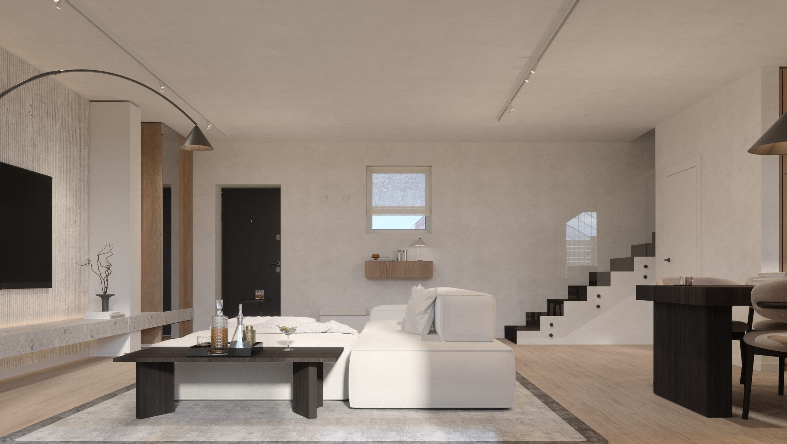 Băneasa House: open-plan living area with a dark coffee table, white sofa and staircase beyond