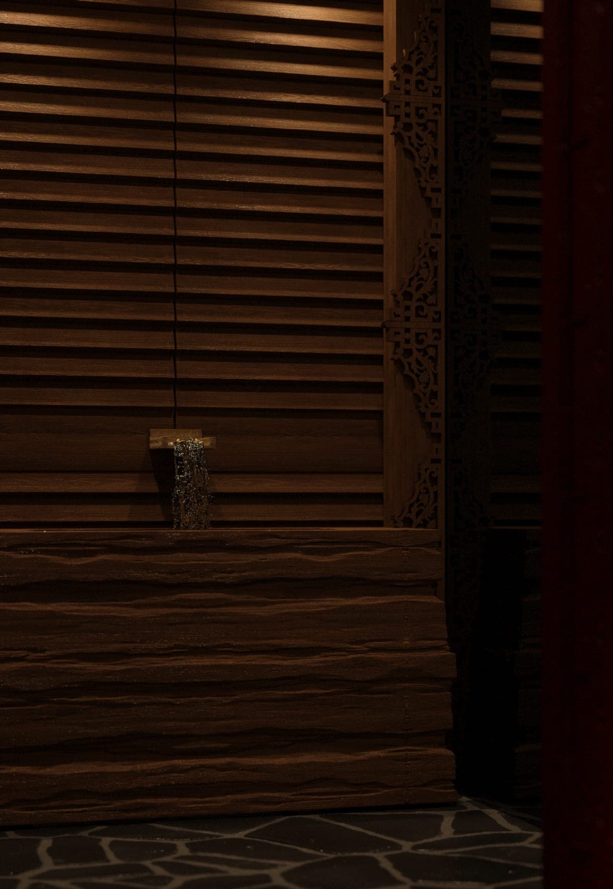 ZURU: slatted timber wall detail in low light