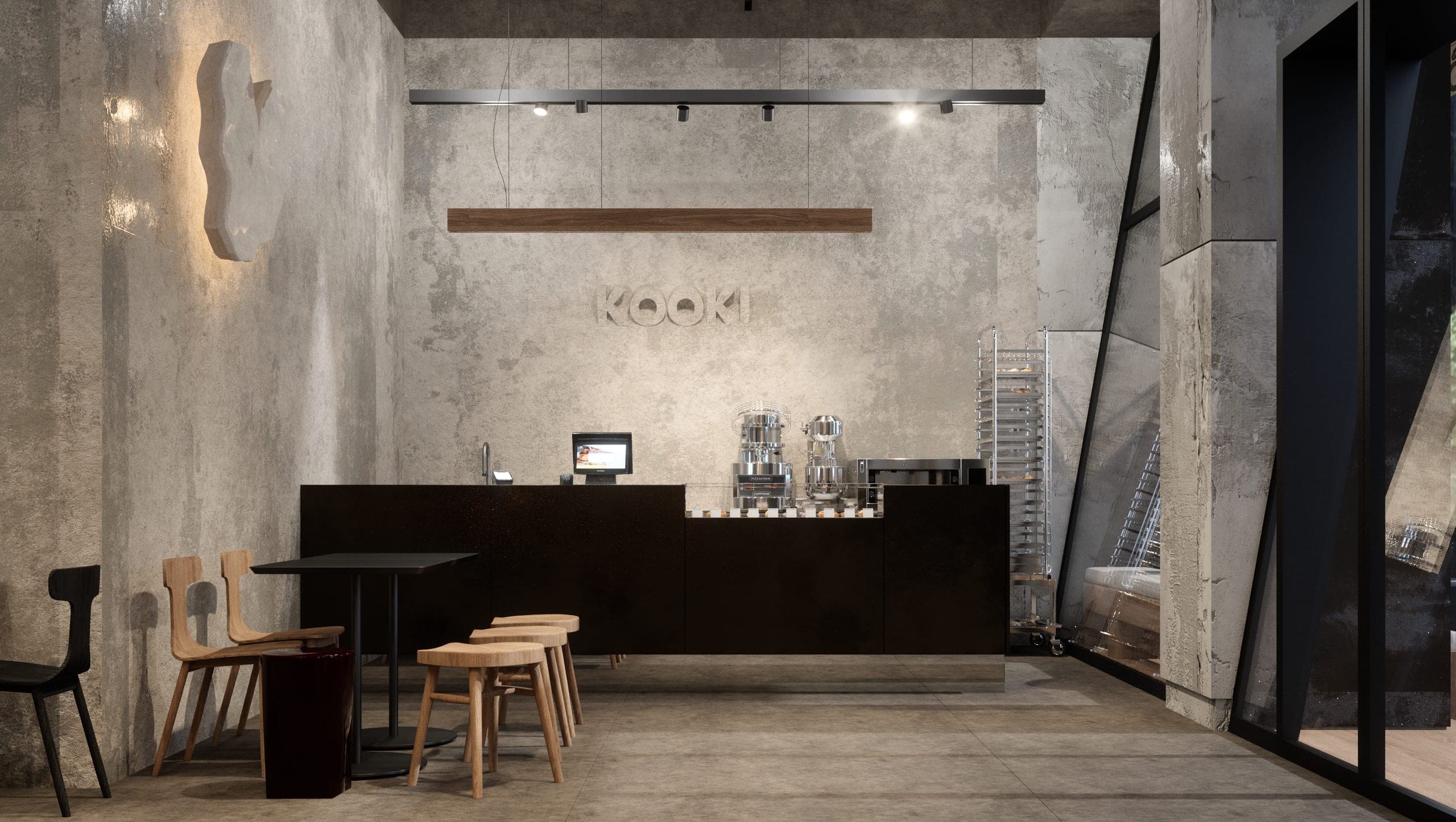 KAVO: dark steel counter against a raw concrete wall, timber stools in front